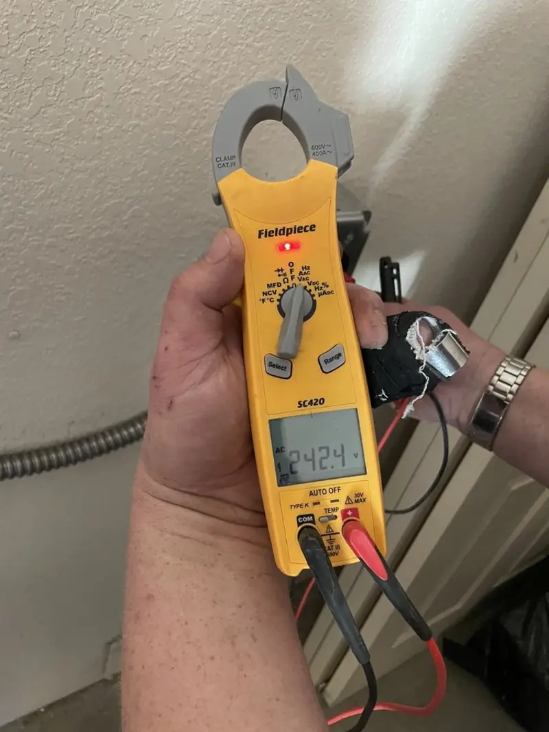 Voltage testing with clamp meter during Ceiling Fan Installation in Plainview